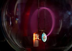 Beam of electrons moving in a circle. Lighting is caused by excitation of atoms of gas in a bulb.