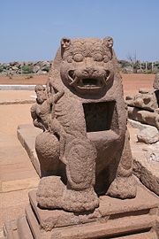 Durga on lion with small carved shrine.