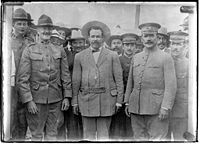 Generals John J. Pershing, Pancho Villa, and Álvaro Obregón pose for a photo at Fort Bliss, Texas, 1913. Immediately behind General Pershing and to the left is his aide-de-camp, 1st Lt. George S. Patton.