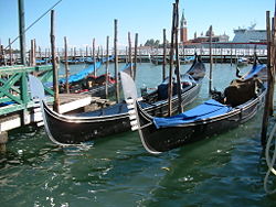 Several gondolas docked in Venice.