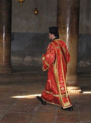 Greek Orthodox deacon  in Bethlehem, wearing an orarion over his sticharion. On his head he wears the clerical kamilavka.