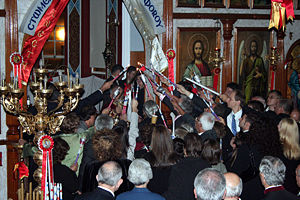 The congregation lighting their candles from the new flame in a Greek Orthodox church