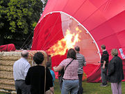 A large flame from propane burners is used to inflate a hot air balloon.