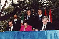 NAFTA Initialing Ceremony, October 1992. From left to right: (standing) President Carlos Salinas, President Bush, Prime Minister Brian Mulroney; (seated) Jaime Serra Puche, Carla Hills, Michael Wilson.