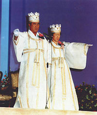 Rev. & Mrs. Moon offering a prayer as officiators at a Blessing Ceremony
