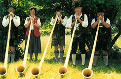 Swiss players of the "alphorn," a brass instrument played by the mountains dwellers.