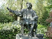 Columbus sits among the flowers and trees of Belgrave Square, London.