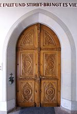 Church wooden relief doors, the panels are low relief and the cross bars are high relief. (Walsertal, Vorarlberg)