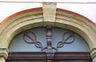 Two caduceuses without wings above a door in Ztracená street, Olomouc, Czech Republic