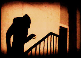 Colorized version of the shadow of the vampire seen climbing stairs in the famous film Nosferatu (1922).