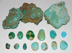 Untreated turquoise from Nevada, United States.Top row: Rough nuggets from the McGuinness MineLower two rows: Blue and green cabochons showing spiderweb, from the Bunker Hill Mine
