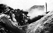A U.S. Marine firing his Browning M1917 machine gun at the Japanese