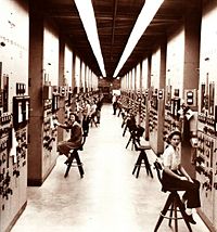 Control panels and operators for calutrons at the Y-12 Plant in Oak Ridge, Tennessee.