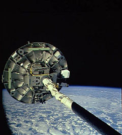 The Wake Shield Facility is deployed by the Space Shuttle's robotic arm. NASA image.