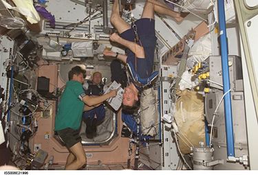 Astronauts on the International Space Station display an example of weightlessness. Michael Foale can be seen exercising in the foreground