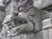 A carved spout (makaras) for water drainage.