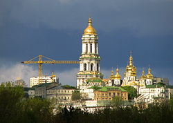 Kiev, an old and a modern city. A construction crane and the towers of the Kiev Monastery of the Caves.