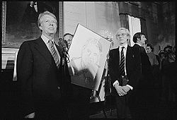 American president Jimmy Carter receiving a portrait from Andy Warhol at the White House in 1977.