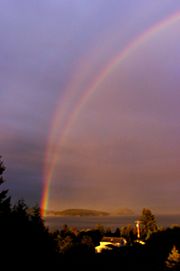 Reflection rainbow and normal rainbow, at sunset