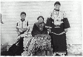 Two young girls and young boy in traditional dress. circa 1920