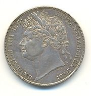 Half-Crown of George IV, 1821. The inscription reads GEORGIUS IIII D[ei] G[ratia] BRITANNIAR[um] REX F[idei] D[efensor] (George IV, by the grace of God King of the Britains (British kingdoms), Defender of the Faith). George IV was the last British King to be shown on coins wearing a Roman-style laurel wreath.