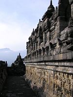 A narrow corridor with reliefs on the wall.