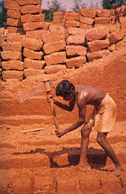 Cutting laterite brickstones in Angadipuram, India.
