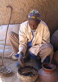 This man in Rhumsiki, Cameroon, tells the future by interpreting the changes in position of various objects as caused by a fresh-water crab through nggàm.