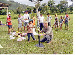 A volunteer teaches tee-ball in Honduras.