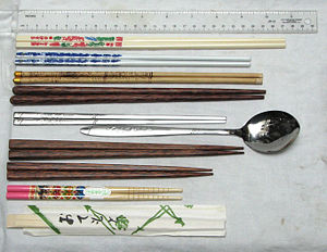 From top to bottom: plastic chopsticks from Taiwan; porcelain chopsticks from mainland China; bamboo chopsticks from Tibet; palmwood chopsticks from Indonesia (Vietnamese style); stainless steel flat chopsticks from Korea (paired with a matching spoon); a Japanese couple's set (two pairs); Japanese child's chopsticks; and disposable "hashi" (in wrapper)