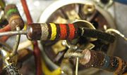 Three carbon composition resistors in a 1960s valve radio.