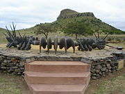 Background, Isandhlwana Hill. Foreground, monument to the dead Impi of the Zulu nation.