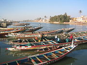 Pirogues, many painted with names of Sufi leaders, jam the Saint-Louis wharf. They are used for fishing, transport, and tourism.