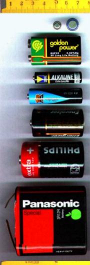 From top to bottom:Two button cells, a 9 volt PP3 battery, a AAA battery, a AA battery, a C battery, a D battery, a large 3R12