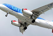 The wing of a landing BMI Airbus A319-100. The slats at the leading edge and the flaps at the trailing edge are extended.