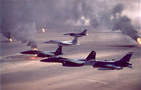 USAF F-16A, F-15C, F-15E combat aircraft flying over burning oil wells (set alight by retreating Iraqi forces) during Desert Storm.
