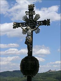 A Czech crucifix depicting Christ posed with uplifted arms.