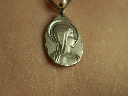 A modern devotional medal featuring the Virgin Mary.