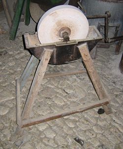 A grinding wheel with a reservoir to hold water as a lubricant and coolant