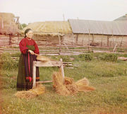 Peasant woman breaking flax