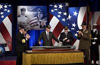 Former President George H. W. Bush views a model of the aircraft carrier that has been named in his honor