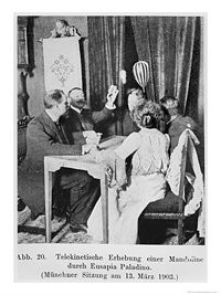Mandolin (striped instrument, top right) levitates during Palladino's séance in Munich, Germany, March 13, 1903.