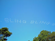 "Bling-bling": Skywriters use smoke to spell.