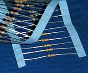 Axial-lead resistors on tape. The tape is removed during assembly before the leads are formed and the part is inserted into the board.