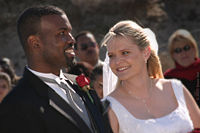 A black/white couple enjoying a moment during their wedding on the beach in Monterey, California