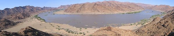 Panorama taken from a hill overlooking a bend in the river, in flood due to above-normal rains.
