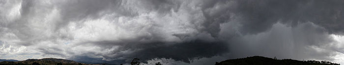 A panorama showing the cloud cover being swept from left to right, with a dark rain cloud on the right.
