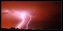 Lightning illuminates the night sky.