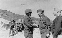 Army Chief of Staff General George C. Marshall (center) and Army Air Forces Commander General Henry H. Arnold confer with Bradley on the beach at Normandy, France in 1944.