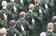 Female soldiers swearing their military oath alongside with male conscripts.